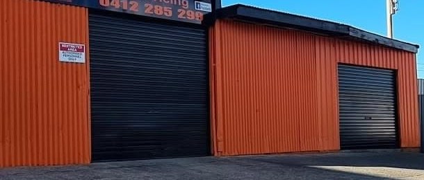 The black roller doors of the B&M Automotive workshop in Edgeworth